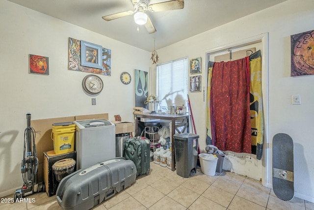 misc room featuring a ceiling fan and tile patterned floors