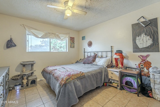 bedroom featuring tile patterned flooring, a textured ceiling, and a ceiling fan