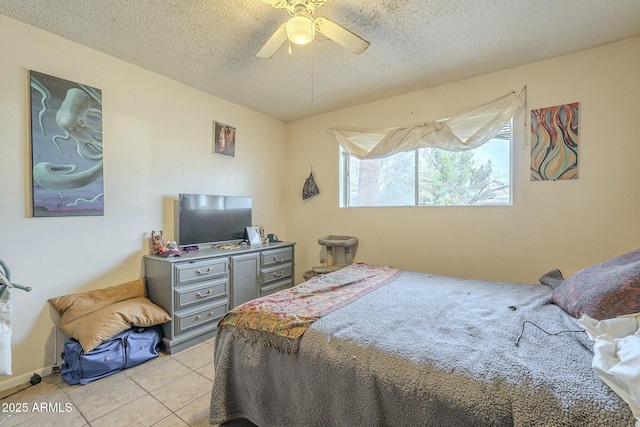 bedroom with a ceiling fan, a textured ceiling, and light tile patterned floors