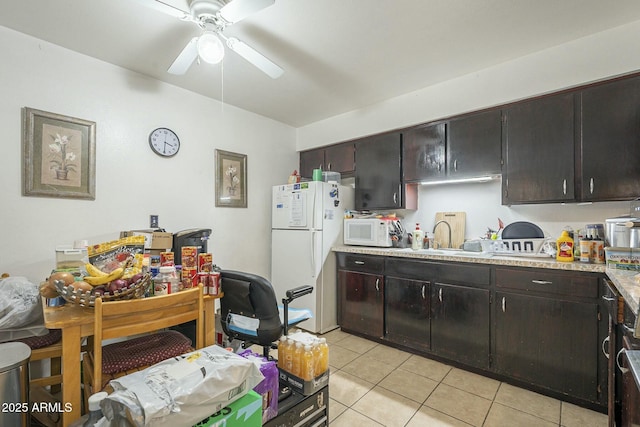 kitchen featuring light countertops, a ceiling fan, light tile patterned flooring, a sink, and white appliances