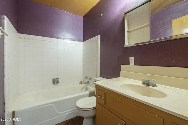 full bathroom featuring a textured wall, wood finished floors, vanity, and toilet