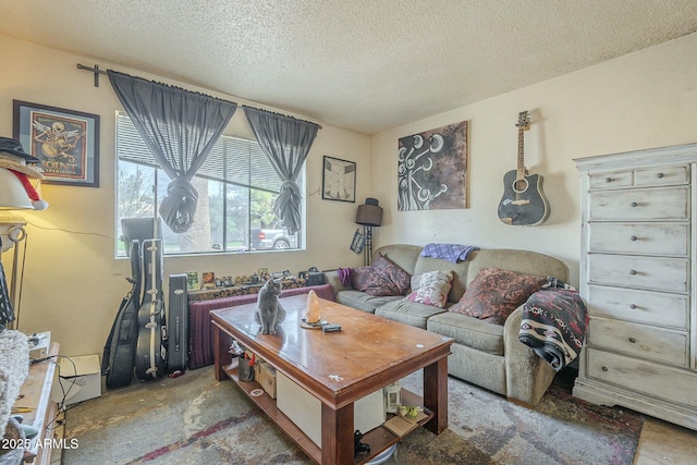 living area featuring unfinished concrete flooring and a textured ceiling