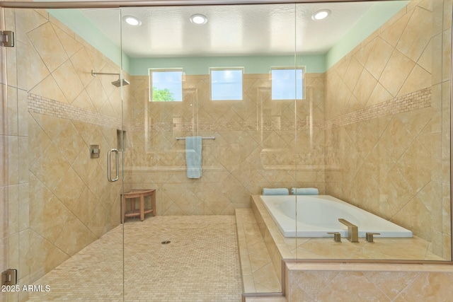 bathroom with a bath and a stall shower