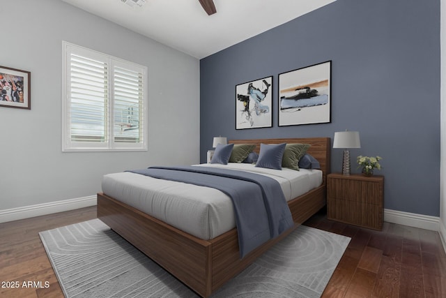 bedroom with visible vents, baseboards, a ceiling fan, and wood finished floors