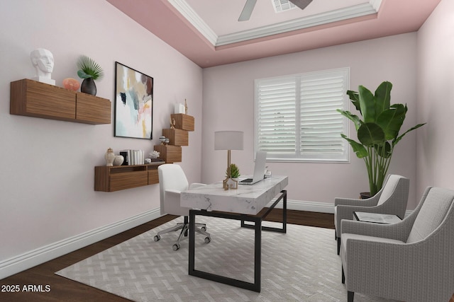 home office with a tray ceiling, wood finished floors, baseboards, and ornamental molding