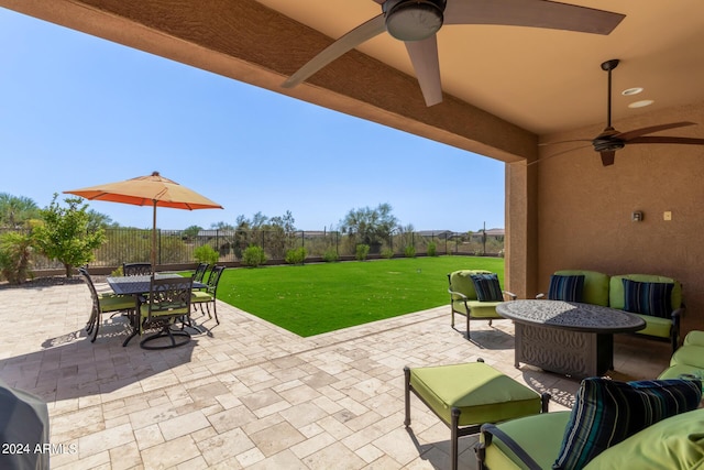 view of patio featuring an outdoor living space, a fenced backyard, and a ceiling fan