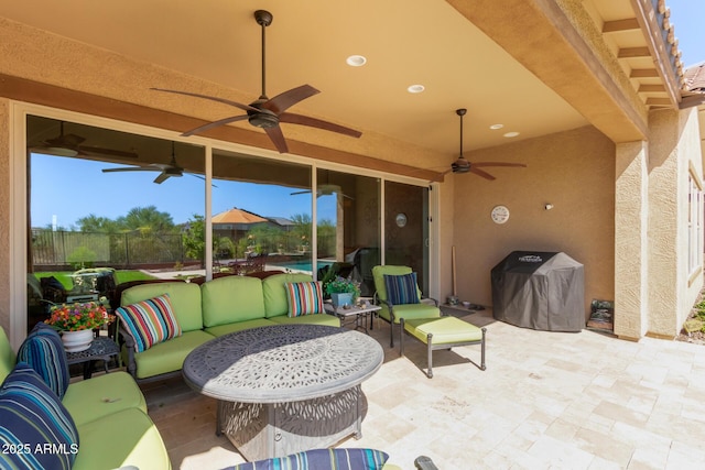 view of patio featuring grilling area, outdoor lounge area, ceiling fan, and fence
