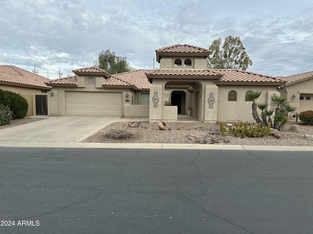 mediterranean / spanish home with a garage