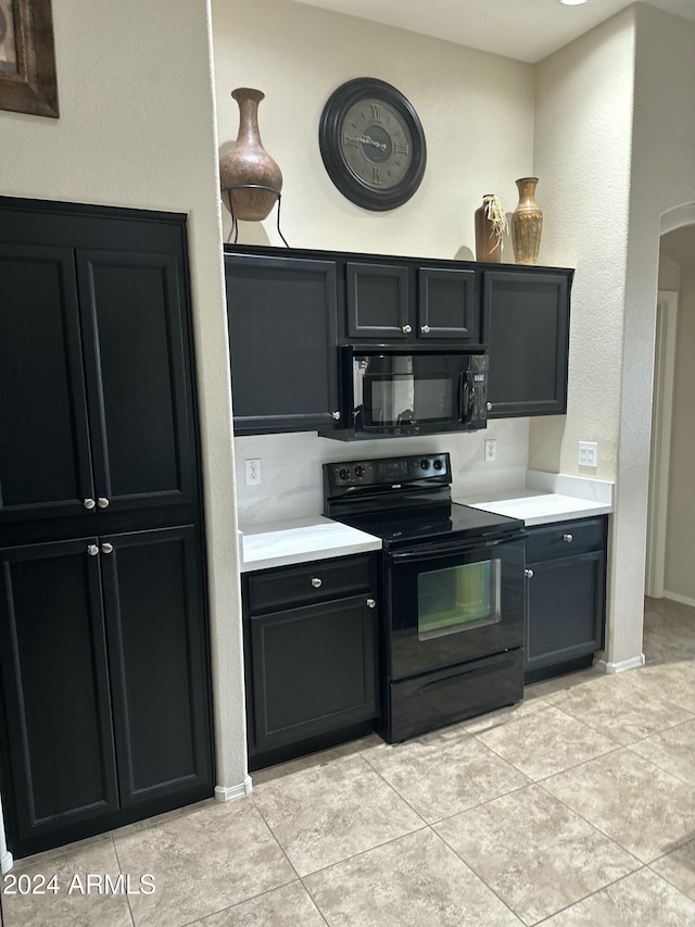 kitchen with light tile patterned floors and black appliances