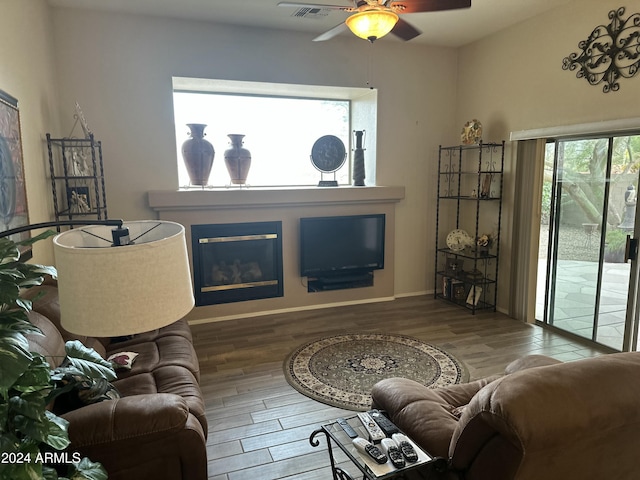 living room with hardwood / wood-style flooring and ceiling fan