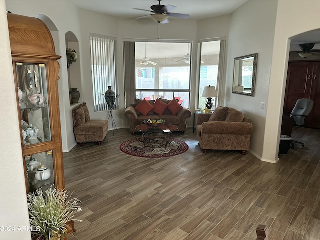 living room with dark hardwood / wood-style flooring and ceiling fan