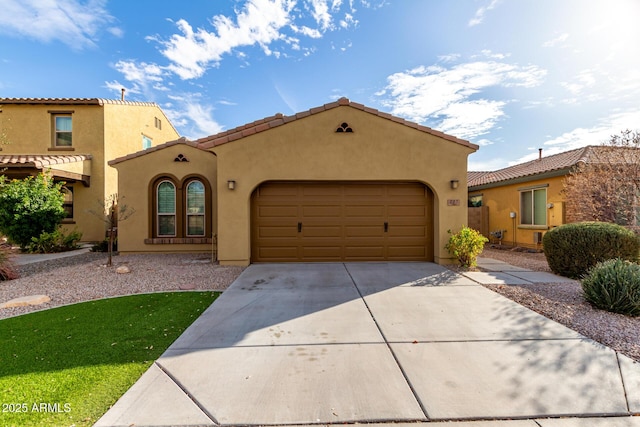 mediterranean / spanish-style home featuring a garage