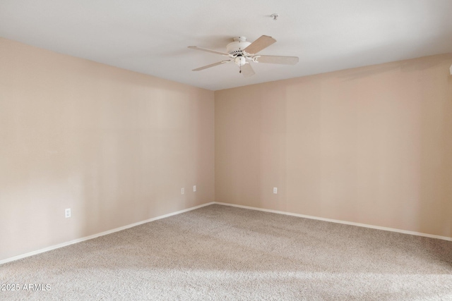 unfurnished room featuring carpet floors, baseboards, and a ceiling fan