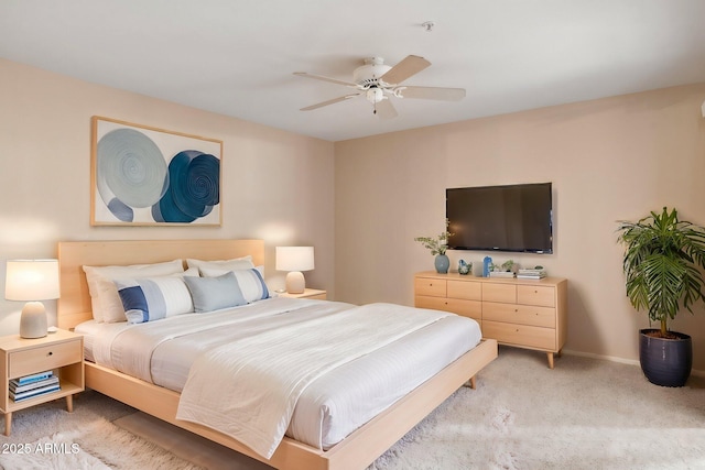 bedroom featuring light carpet, ceiling fan, and baseboards