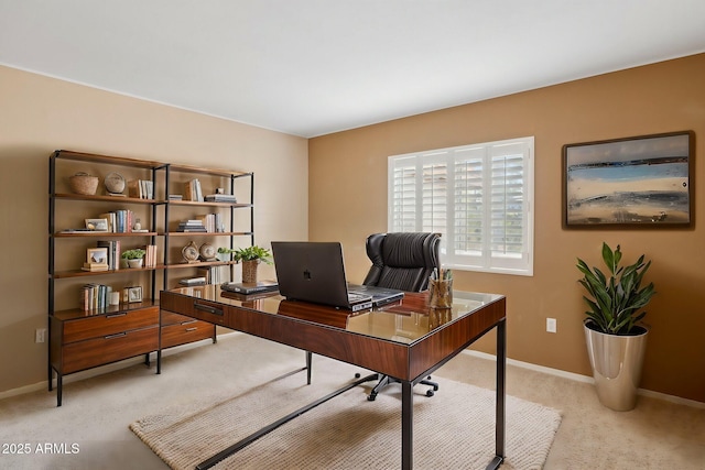 office area featuring light carpet and baseboards