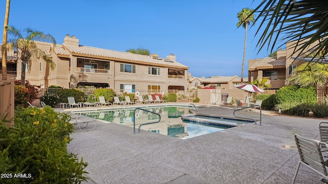 pool featuring a patio area and fence