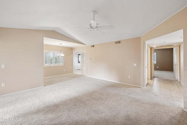 spare room with visible vents, light tile patterned floors, vaulted ceiling, ceiling fan with notable chandelier, and light carpet