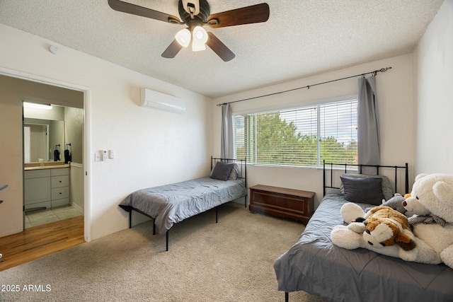 730 Mingus Ave, Prescott, AZ 86301 - bedroom featuring a wall unit AC, light colored carpet, a textured ceiling, ceiling fan, and ensuite bathroom