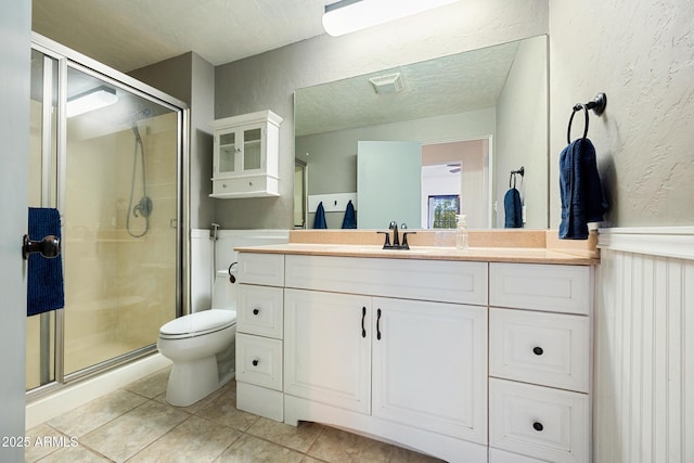 730 Mingus Ave, Prescott, AZ 86301 - bathroom featuring a textured wall, tile patterned floors, vanity, a shower stall, and toilet