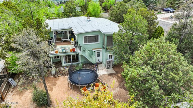 730 Mingus Ave, Prescott, AZ 86301 - back of property featuring a trampoline, stairway, and stucco siding