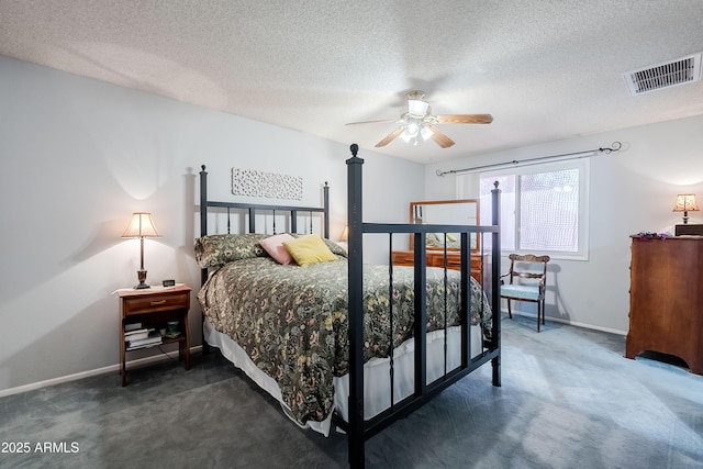 carpeted bedroom featuring ceiling fan and a textured ceiling