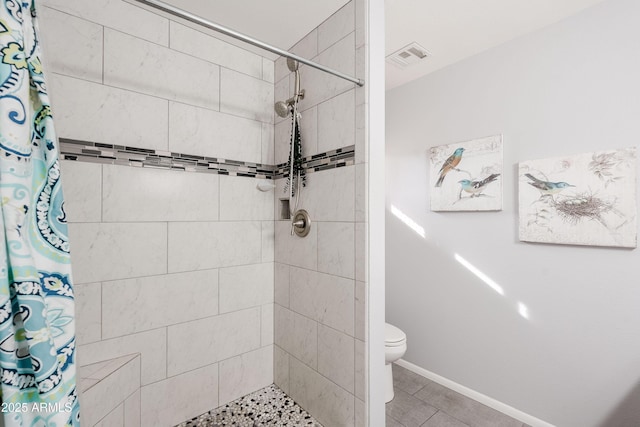 bathroom featuring curtained shower and toilet