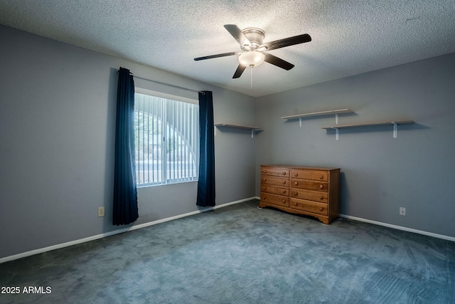 unfurnished bedroom featuring a textured ceiling, ceiling fan, and dark colored carpet