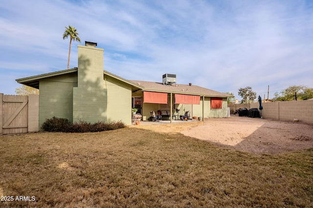 back of house with a lawn, central AC, and a patio area