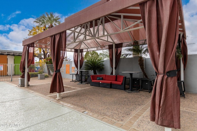 view of patio / terrace featuring a gazebo, fence, and an outdoor hangout area
