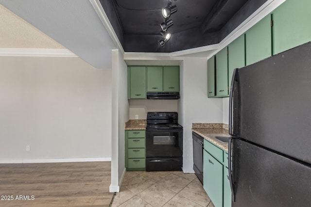 kitchen with black appliances, green cabinetry, under cabinet range hood, and track lighting