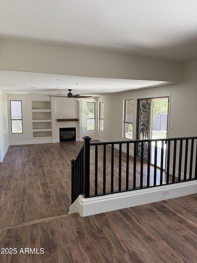33220 N 60th Way, Scottsdale, AZ 85266 - unfurnished living room with wood finished floors, a fireplace, and plenty of natural light