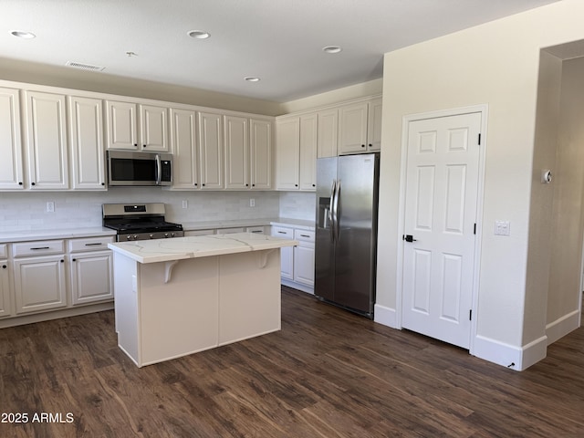 33220 N 60th Way, Scottsdale, AZ 85266 - kitchen featuring appliances with stainless steel finishes, dark wood finished floors, a center island, backsplash, and recessed lighting