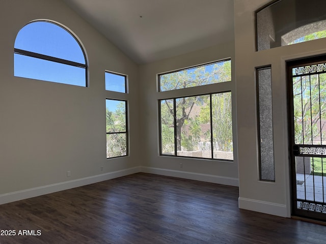 33220 N 60th Way, Scottsdale, AZ 85266 - empty room with high vaulted ceiling and dark wood-type flooring