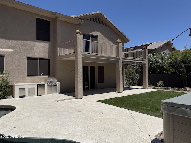 33220 N 60th Way, Scottsdale, AZ 85266 - back of property featuring a balcony, an outdoor kitchen, a patio area, and stucco siding