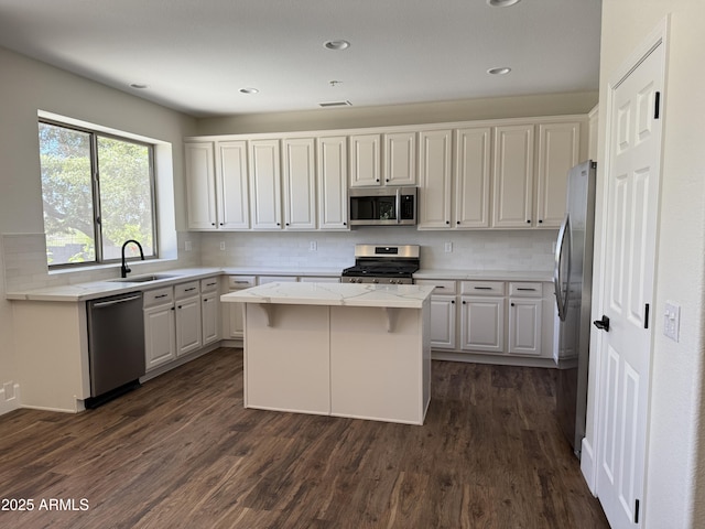 33220 N 60th Way, Scottsdale, AZ 85266 - kitchen featuring stainless steel appliances, a center island, backsplash, white cabinetry, and recessed lighting