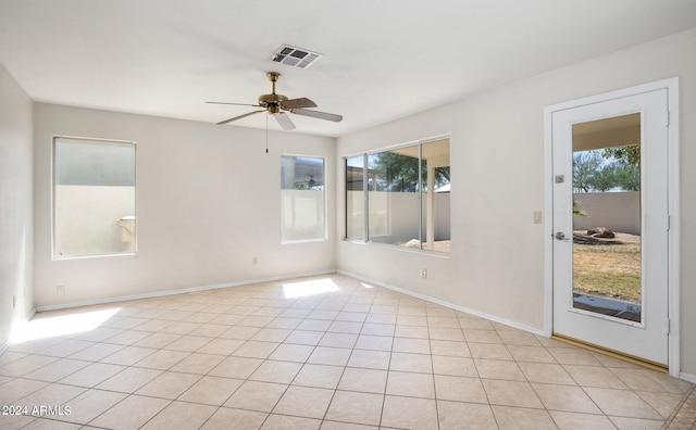 unfurnished room featuring ceiling fan, light tile patterned floors, and a wealth of natural light