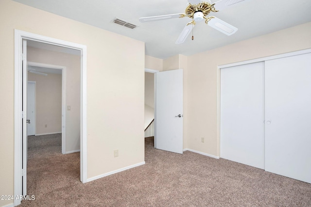 unfurnished bedroom with ceiling fan, a closet, and carpet