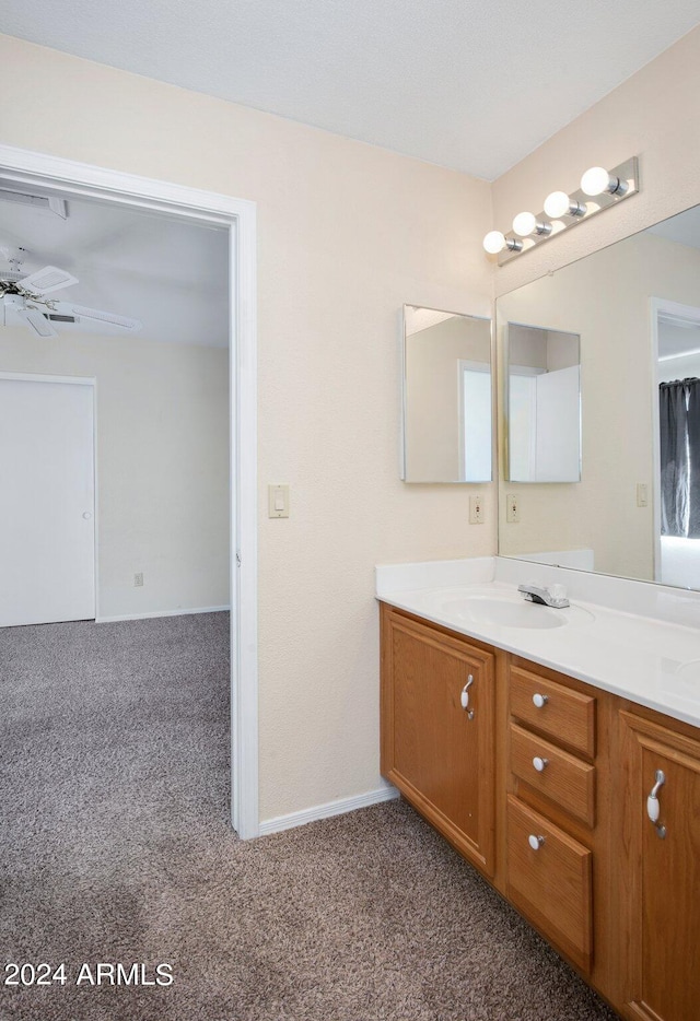 bathroom with ceiling fan and vanity