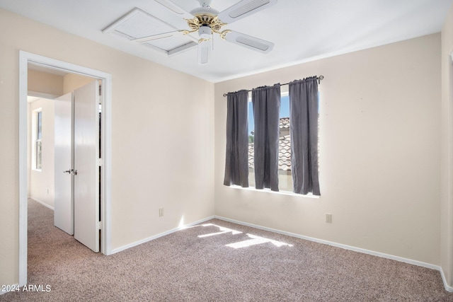 carpeted empty room featuring ceiling fan