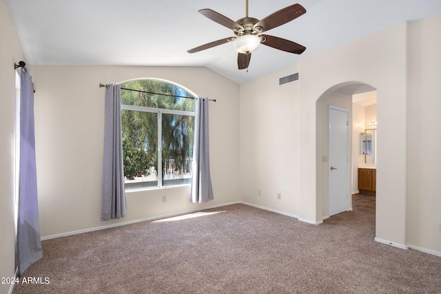 unfurnished room with lofted ceiling, ceiling fan, plenty of natural light, and carpet floors