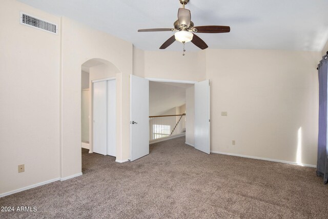 unfurnished room with carpet floors, lofted ceiling, and ceiling fan