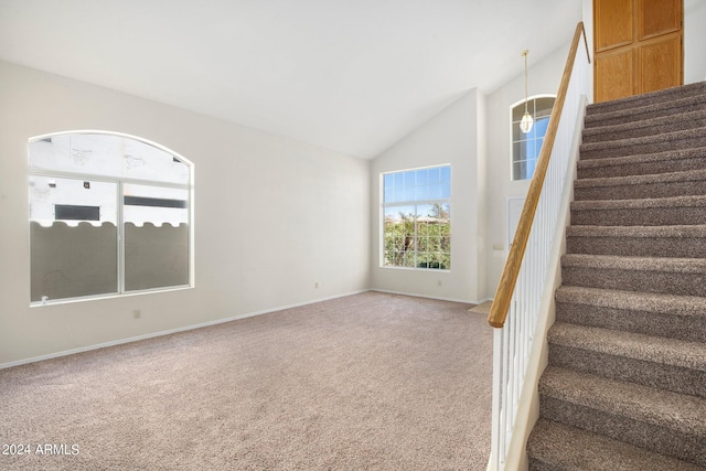 stairs with carpet flooring and vaulted ceiling