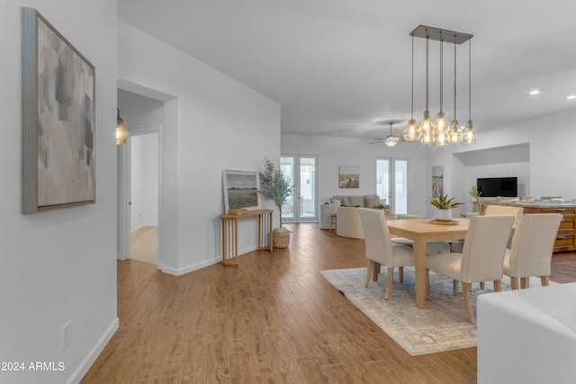 dining room with french doors, light wood-type flooring, and ceiling fan