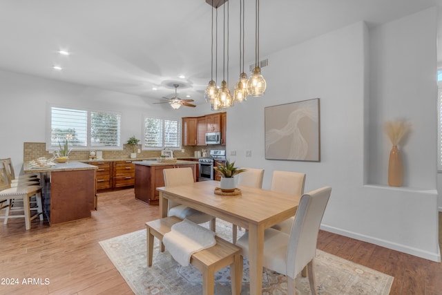 dining room featuring ceiling fan and light hardwood / wood-style floors