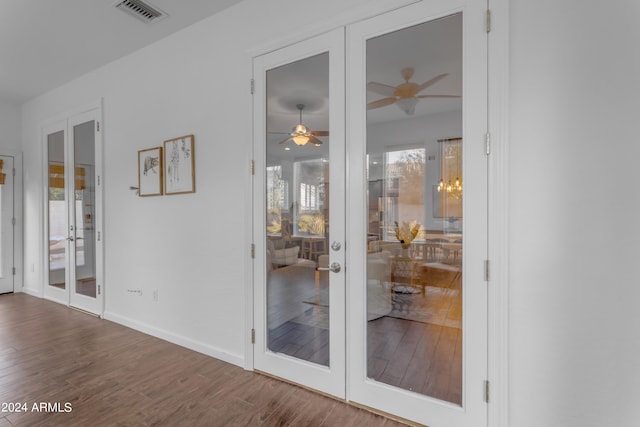 interior space with dark wood-type flooring, plenty of natural light, and french doors