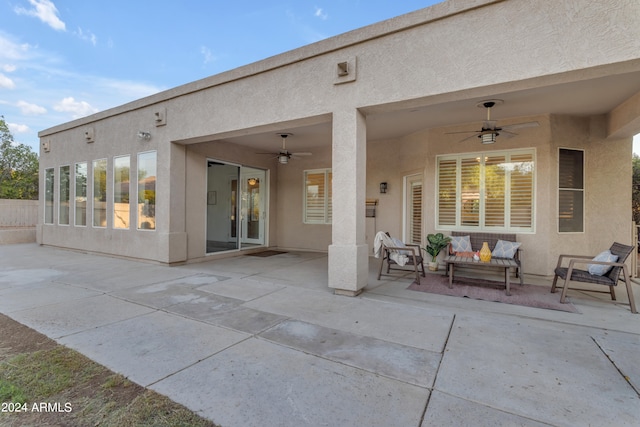 back of house with ceiling fan, an outdoor hangout area, and a patio