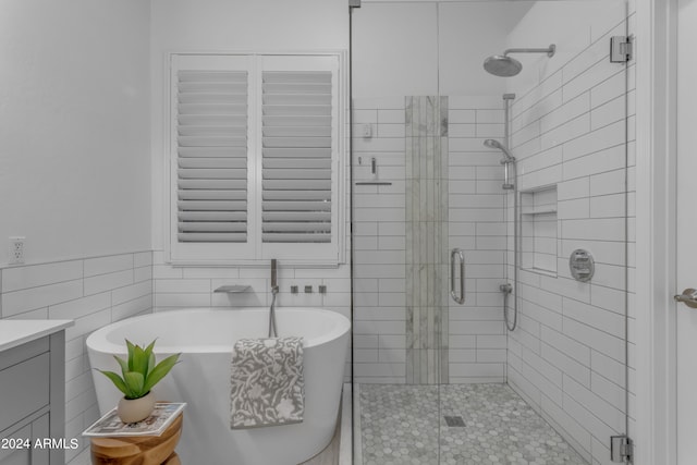 bathroom with vanity, tile walls, tile patterned flooring, and separate shower and tub