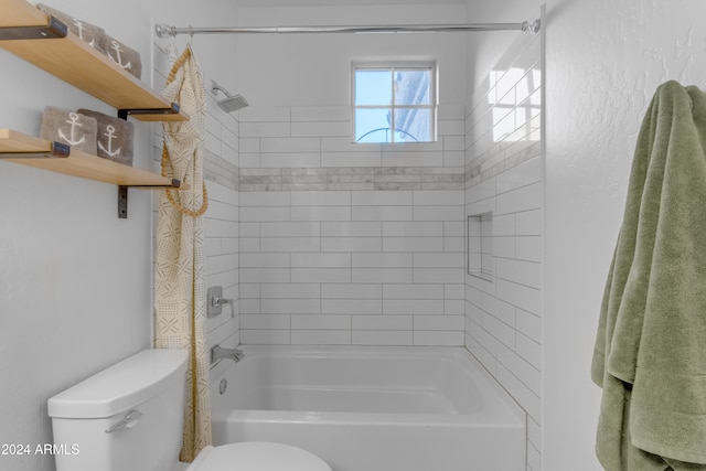 bathroom featuring tiled shower / bath combo and toilet