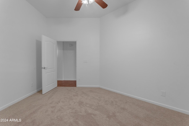 carpeted spare room with ceiling fan