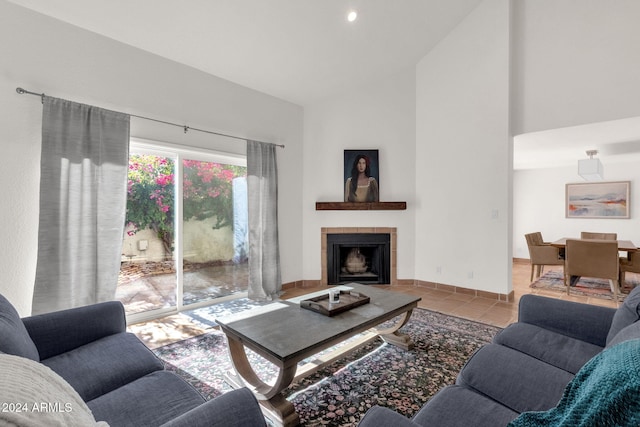 tiled living room featuring a fireplace and high vaulted ceiling